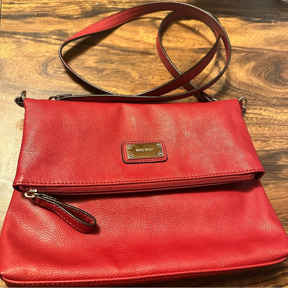 Leather cross body with adjustable straps .nail Polish stain not very noticeable